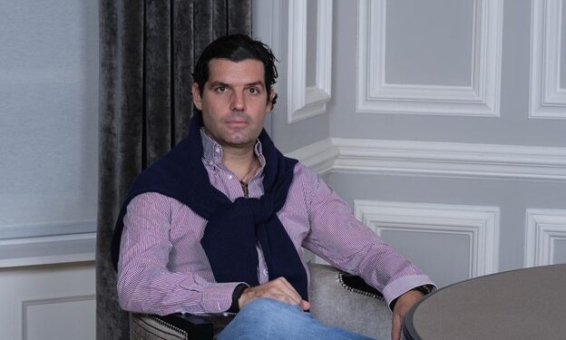 Alejandro Betancourt is setting on chair